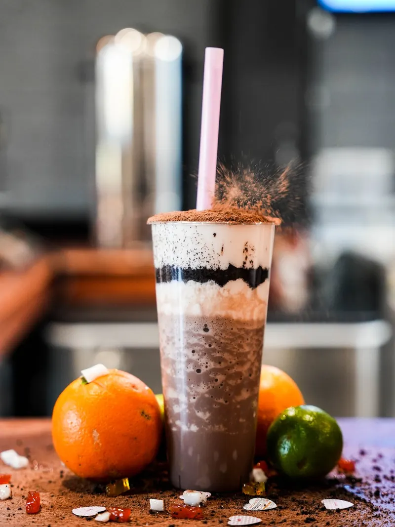 Dr. Tea layered chocolate drink with a cocoa dusting, oranges, and lime