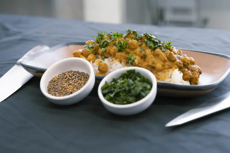 CSMP chickpea masala over rice with spice and herb sides