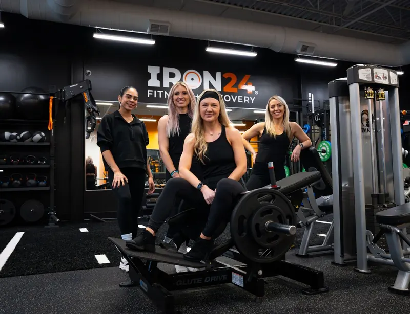 Iron 24 team posing on strength equipment