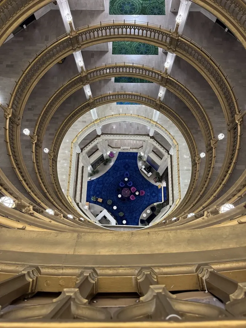 Top-down view spiraling into the blue-carpeted rotunda