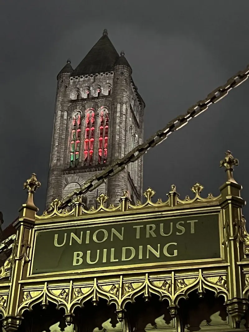 The lit Union Trust Building marquee at night