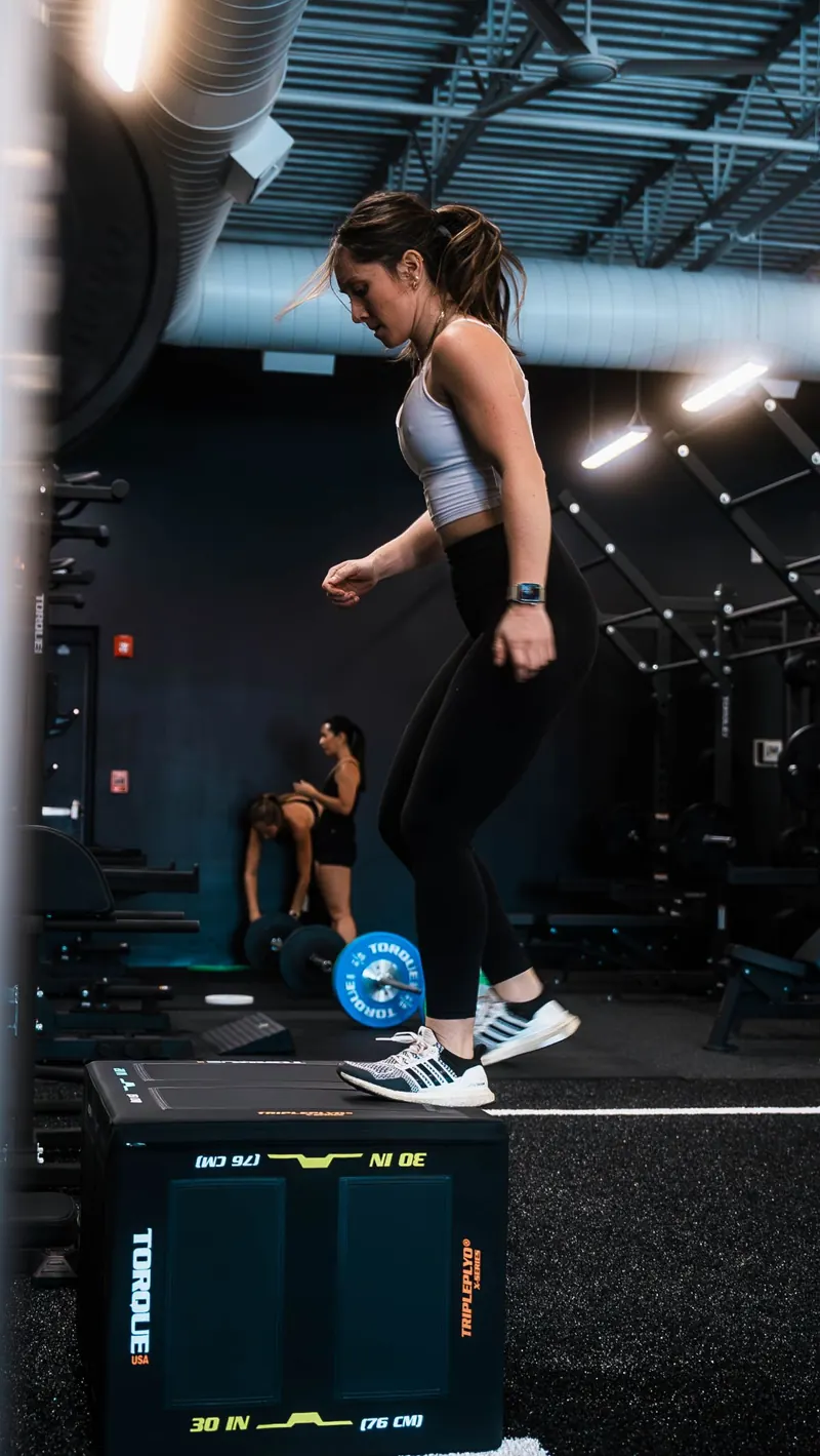 Box jump onto a plyo box at Iron 24