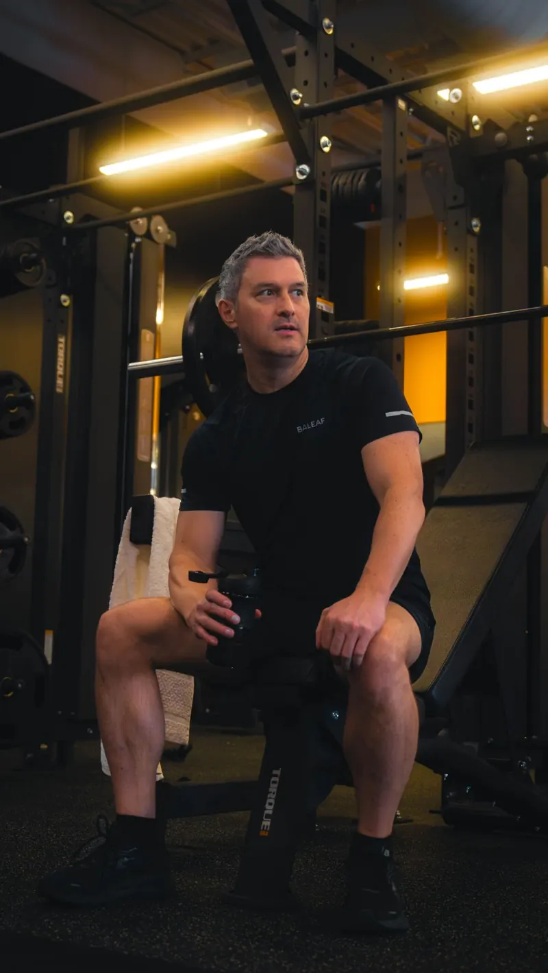 Resting between sets at an Iron 24 squat rack