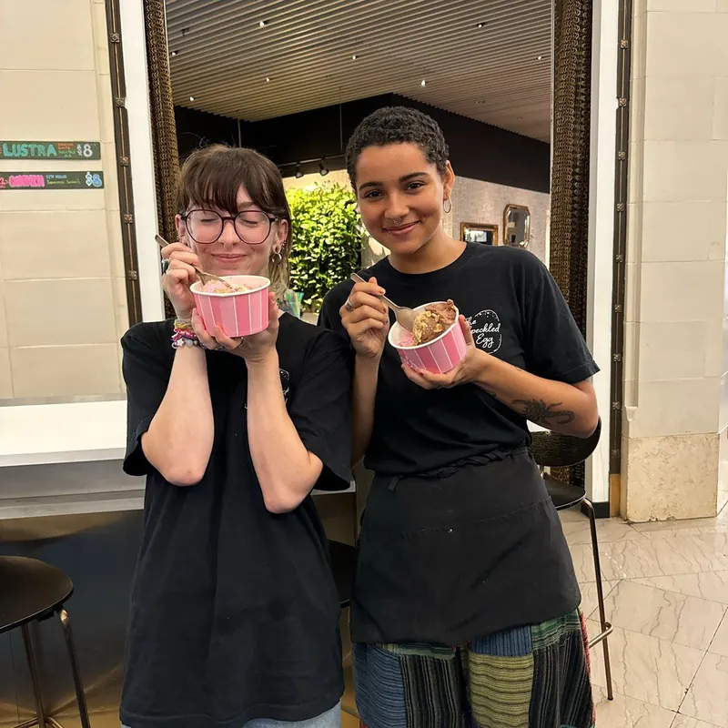 Two tenants smiling over ice cream at the summer ice cream social