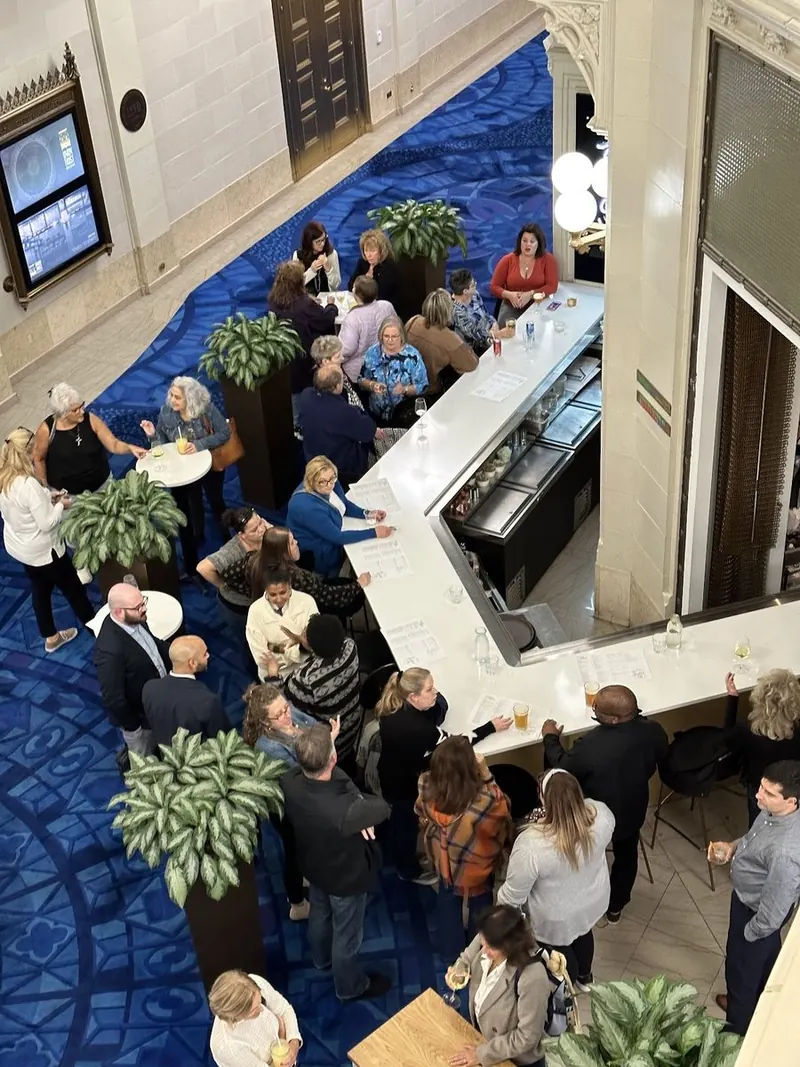 Balcony view of a packed tenant event at the lobby bar