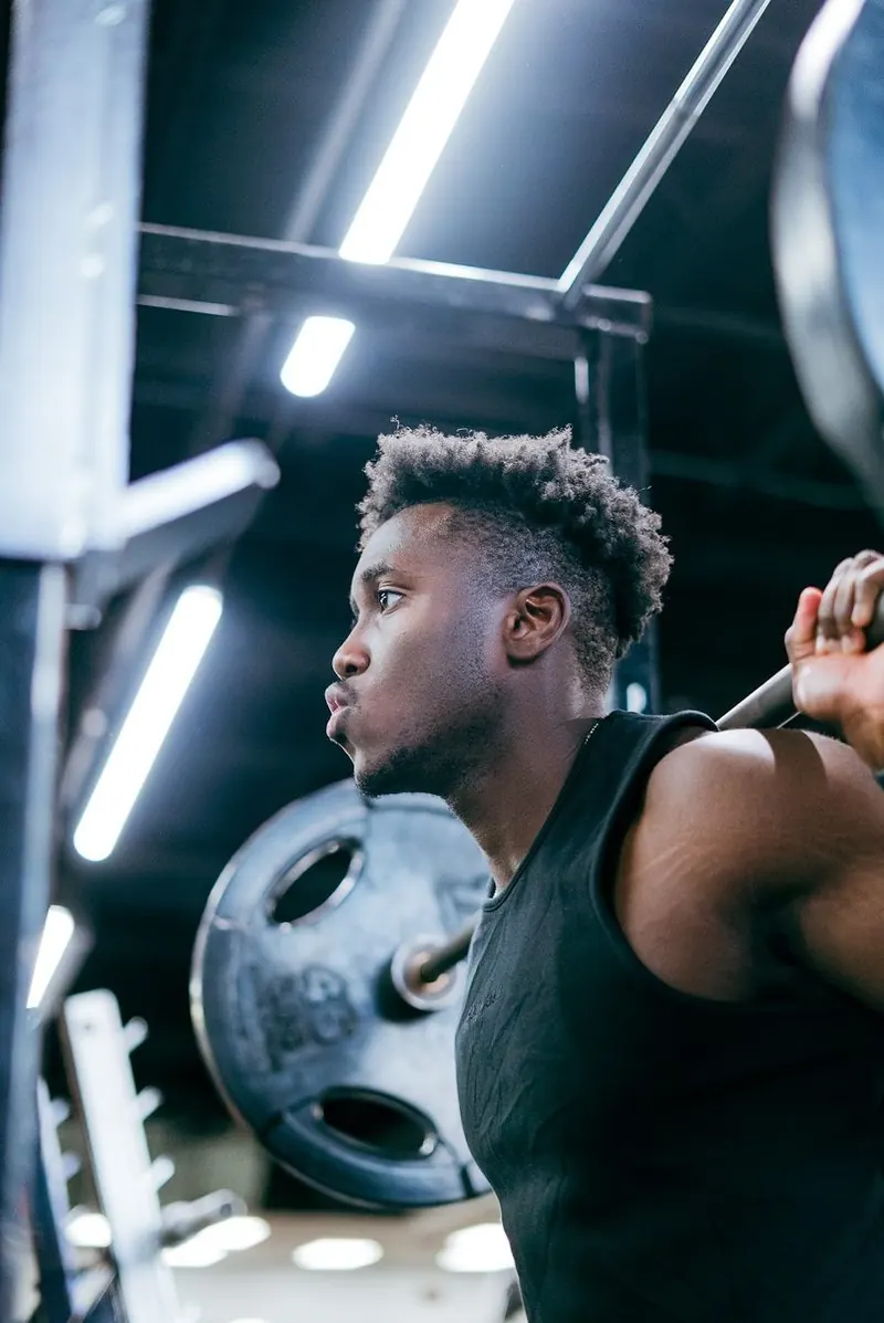 Member setting up under a squat bar
