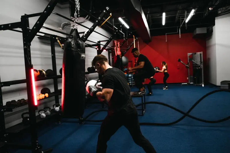 Member working the heavy bag on the turf at X Shadyside