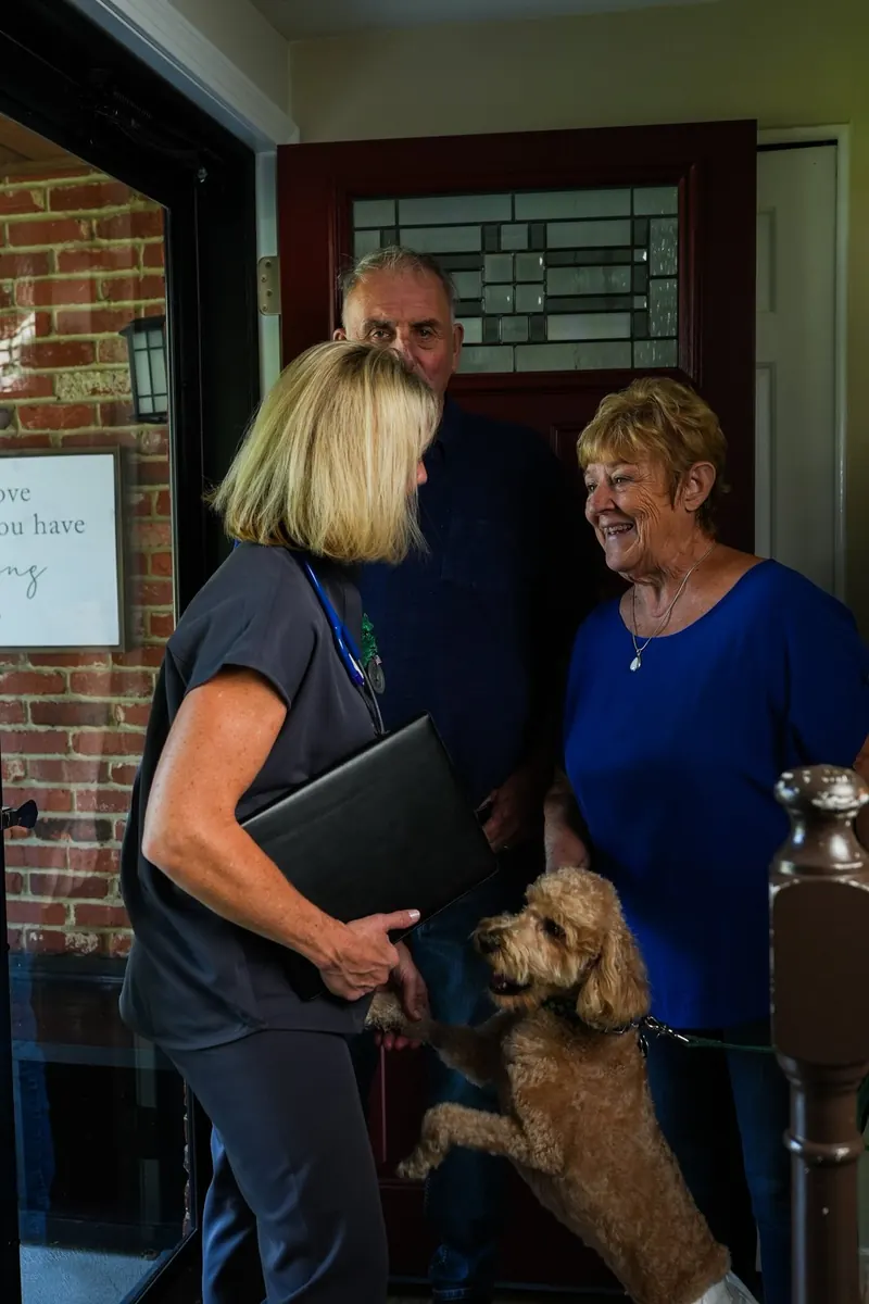 A dog jumps up to greet Kathy Fadgen at the clients&rsquo; front door, everyone laughing