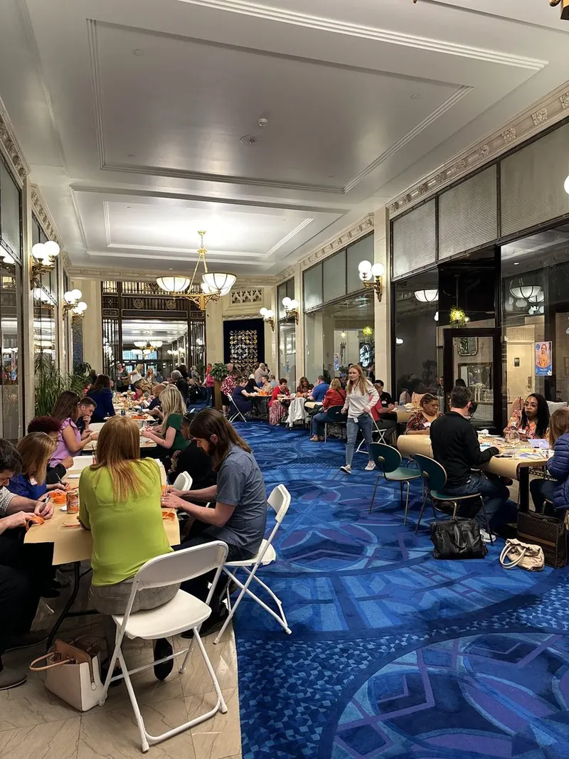 Lobby arcade packed with tenants at tables for the Make-A-Wish fundraiser