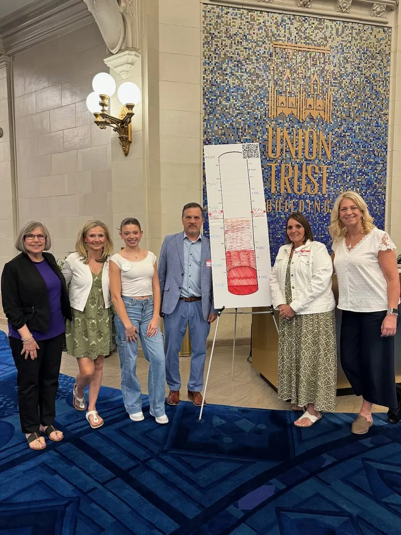 Organizers with the fundraising thermometer at the Union Trust mosaic wall