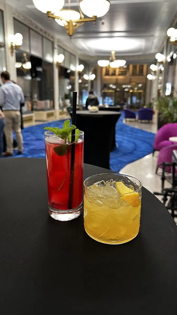 Holiday cocktails on a high-top in the chandeliered lobby