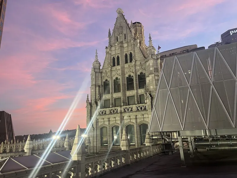 The building&rsquo;s Gothic gable against a sunset sky