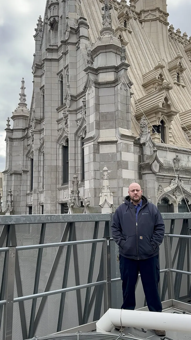 Union Trust Building engineer on the roof, framed by the Gothic tower